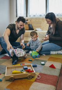 Full length of father and daughter playing at home