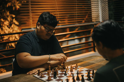 Man playing chess on table