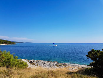 Scenic view of sea against clear blue sky