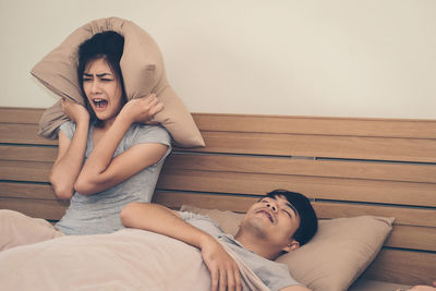 Young couple lying on bed at home