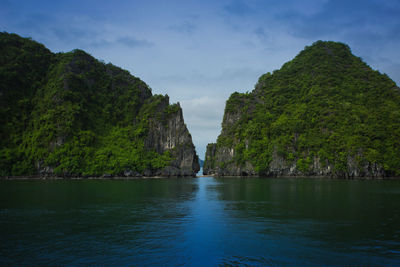 Scenic view of sea and mountains against sky