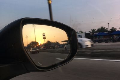 Reflection of road in side-view mirror of car