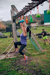 Side view of woman exercising at boot camp