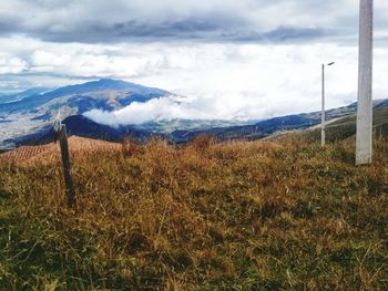 Scenic view of landscape against cloudy sky