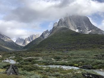 Scenic view of mountains against cloudy sky