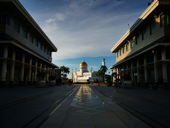 Street amidst buildings against sky in city