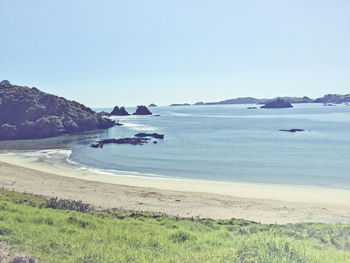 View of calm beach against clear sky