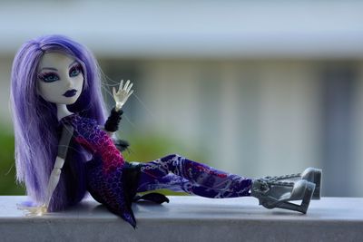 Close-up of toy figurine on purple outdoors