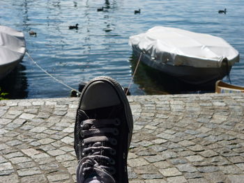 Low section of boat on footpath by lake