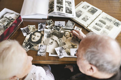 Senior couple with photo albums and old photographies at home