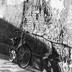 Bicycle parked on wall