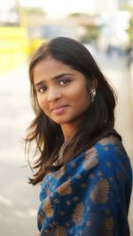 Portrait of smiling woman standing outdoors