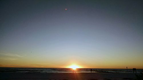 Scenic view of sea against clear sky during sunset