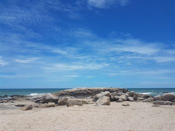 Rocks on beach against sky