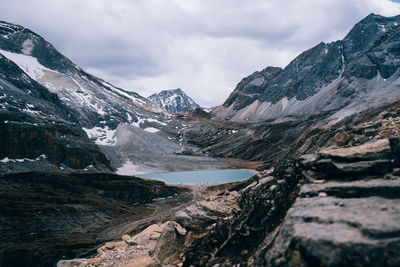 Scenic view of mountains against cloudy sky