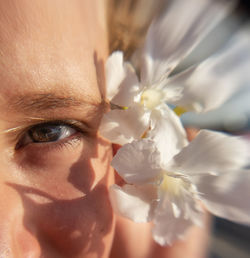 Close-up of woman with pink flower
