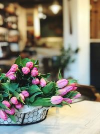 Close-up of pink flowers in basket on table
