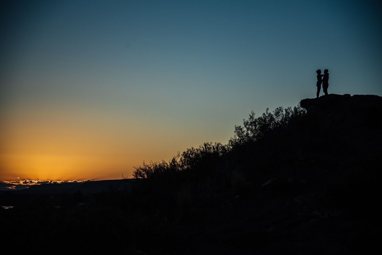 SILHOUETTE MAN STANDING AGAINST SKY AT SUNSET