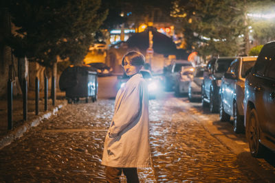 Woman walking on street at night