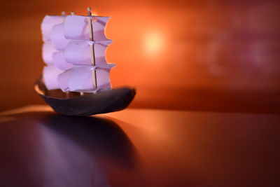 Close-up of toy boat on table in illuminated room