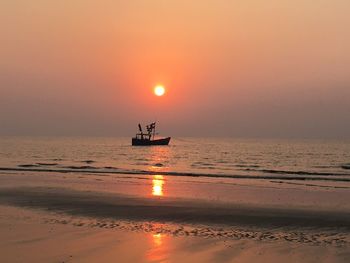 Scenic view of sea against orange sky