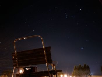 Low angle view of illuminated light against sky at night