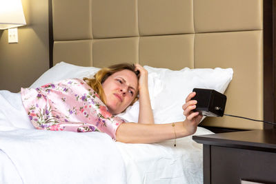 Woman lying on bed at home
