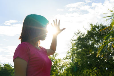 Rear view of woman against bright sun