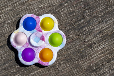 High angle view of multi colored eggs on table