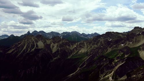 Scenic view of mountains against cloudy sky