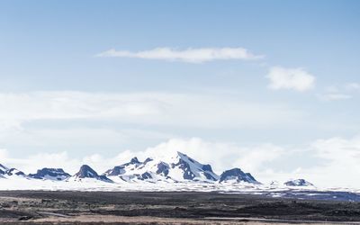 Scenic view of snow covered mountains against sky