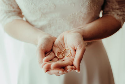 Midsection of bride holding hands