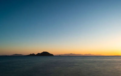 Scenic view of sea against clear sky during sunset