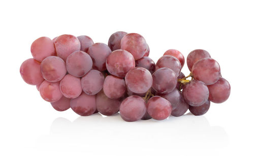 Close-up of grapes against white background