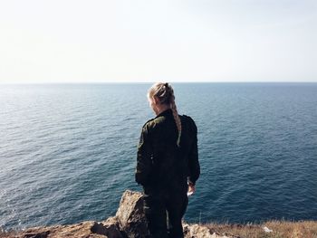 Woman standing by seashore