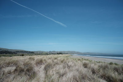 Scenic view of landscape against blue sky