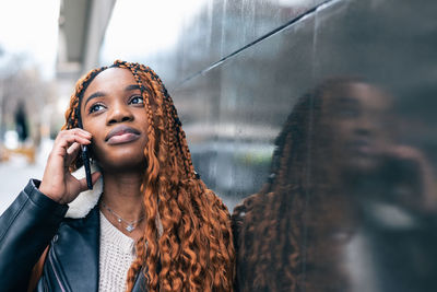 Portrait of young woman looking away outdoors