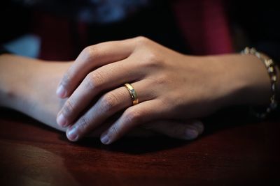 Close-up of hands on table