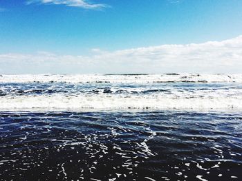 Scenic view of sea against cloudy sky