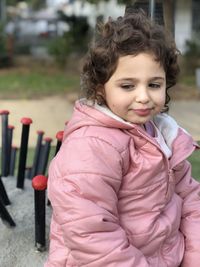 Thoughtful girl wearing warm clothing while standing outdoors