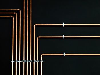 Metallic pipes on black background