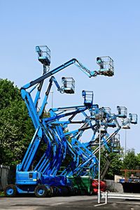 Low angle view of ferris wheel against clear blue sky