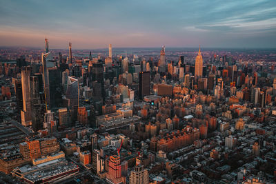 High angle view of buildings in city at sunset