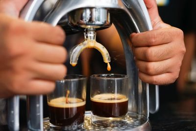 Man pouring coffee in cup