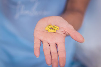 Cropped hand of woman holding a pill