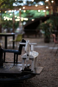 Empty chairs and table in restaurant at night