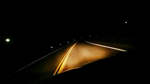 Illuminated tunnel at night