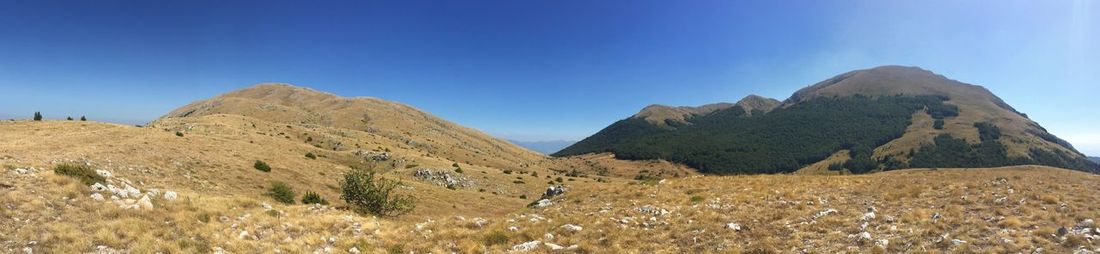 Scenic view of mountains against clear blue sky