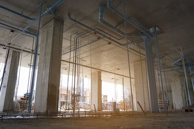 Plumbing and drainage systems are installed inside the building under construction.