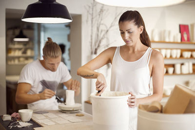 Colleagues working in crockery workshop